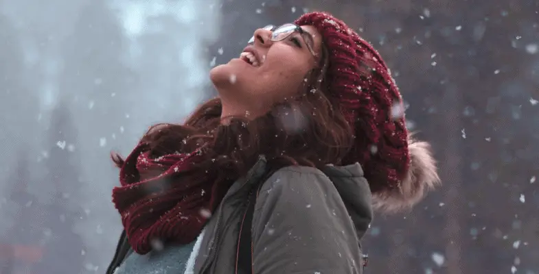 woman enjoying the snow fall