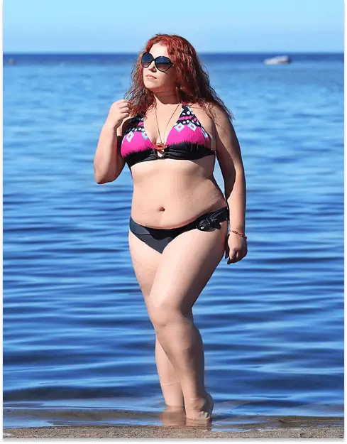 woman in pattern top solid bottom bikini