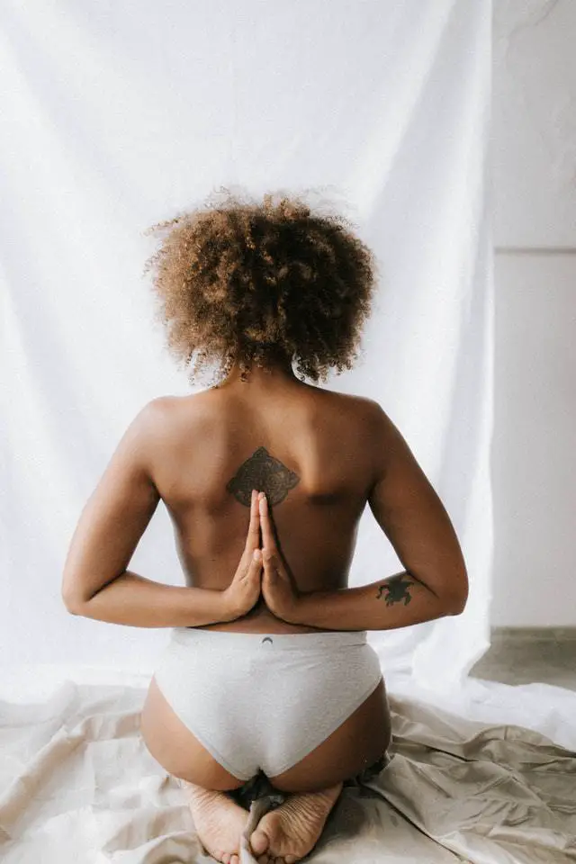 shirtless woman doing yoga