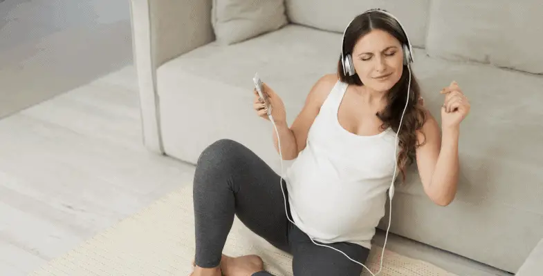 pregnant with headphones and happy