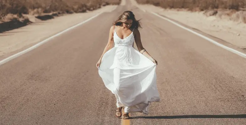 woman wearing elopement dress in the middle of the highway
