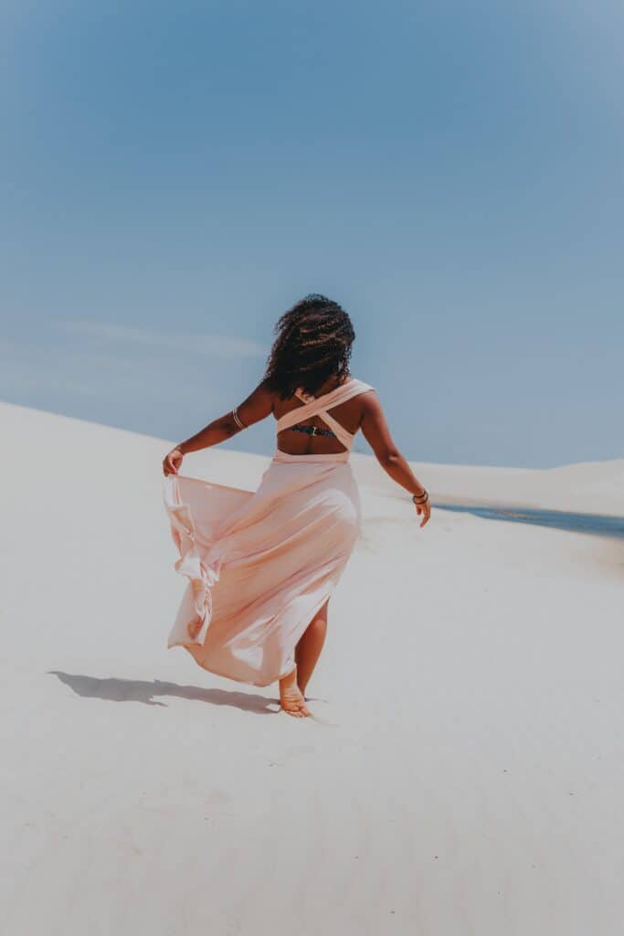 woman walking on sand in plus size formal dress