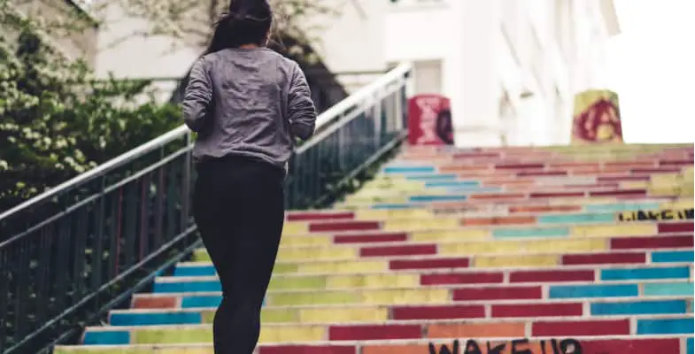 Woman jogging up steps